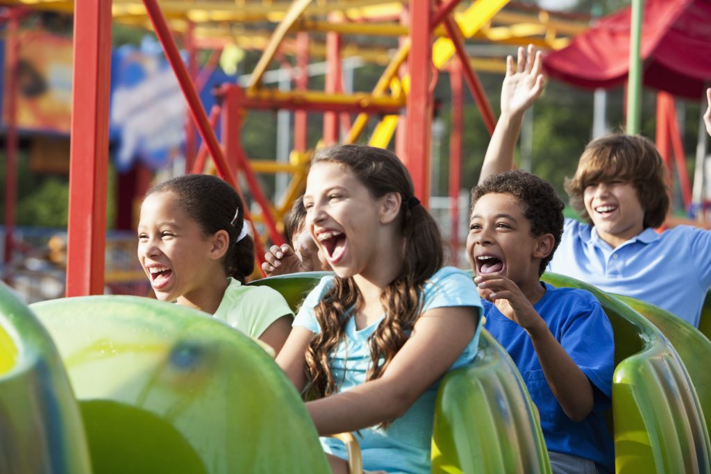 Children riding a roller coaster